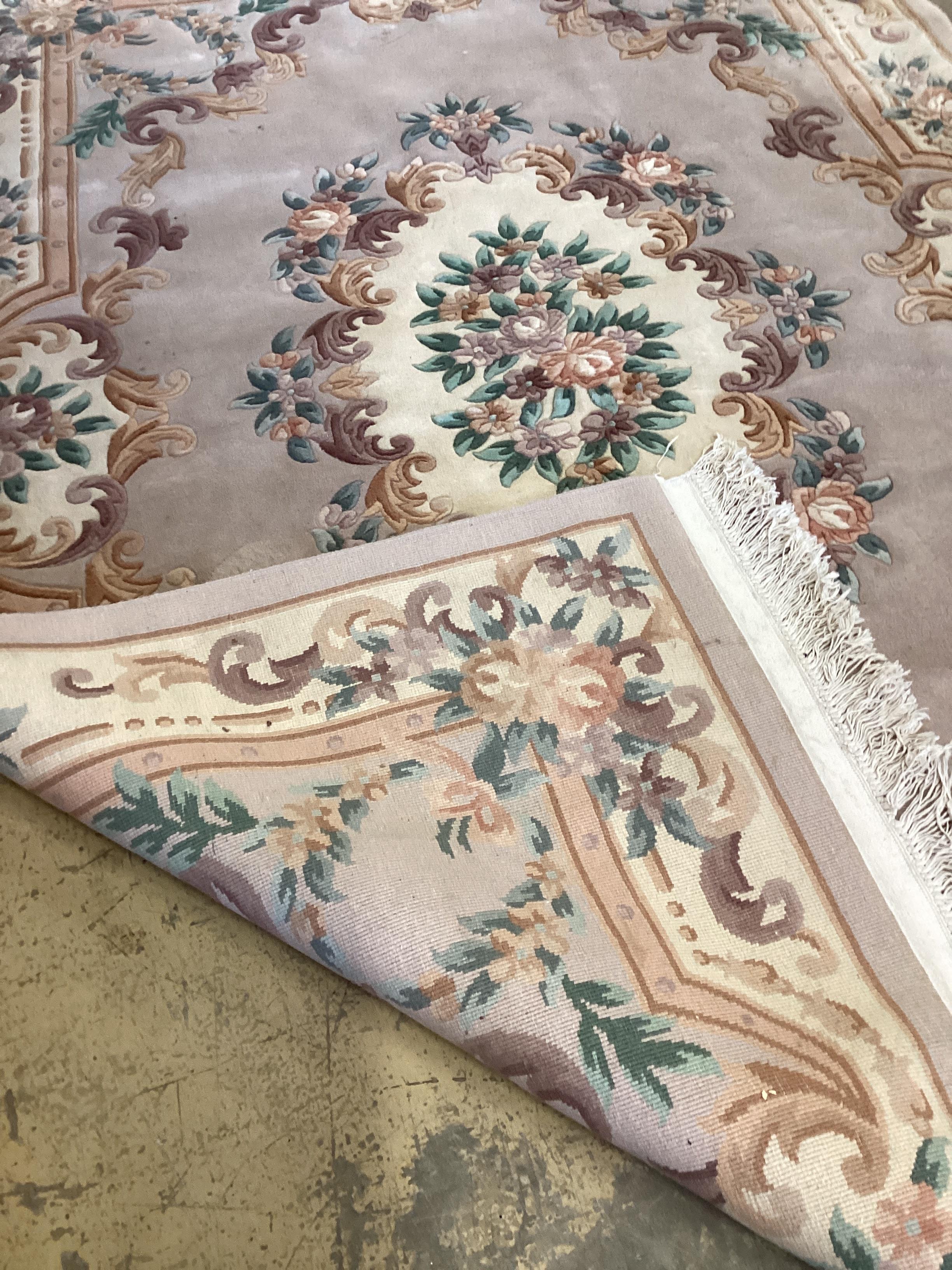 A Chinese fawn ground floral carpet, 275 x 184cm